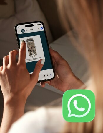 A person uses WhatsApp on a smartphone, receiving Carado news and viewing a motorhome floor plan